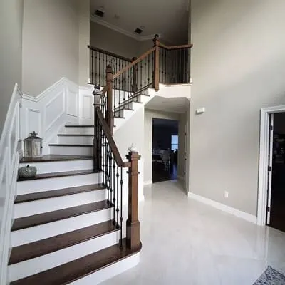 painted Worldly Gray entryway with grand staircase