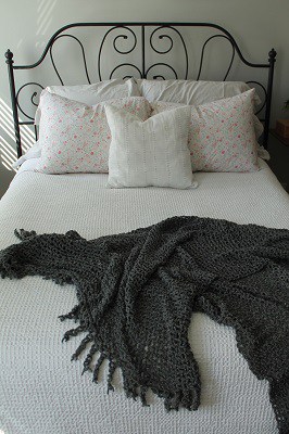 bed-with-pillows-and-gray-blanket