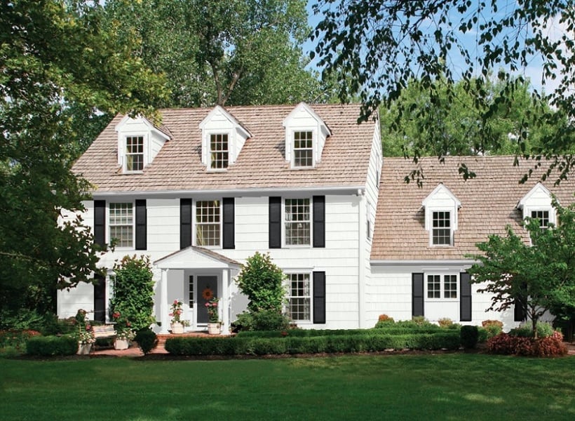 white siding house with brown roof
