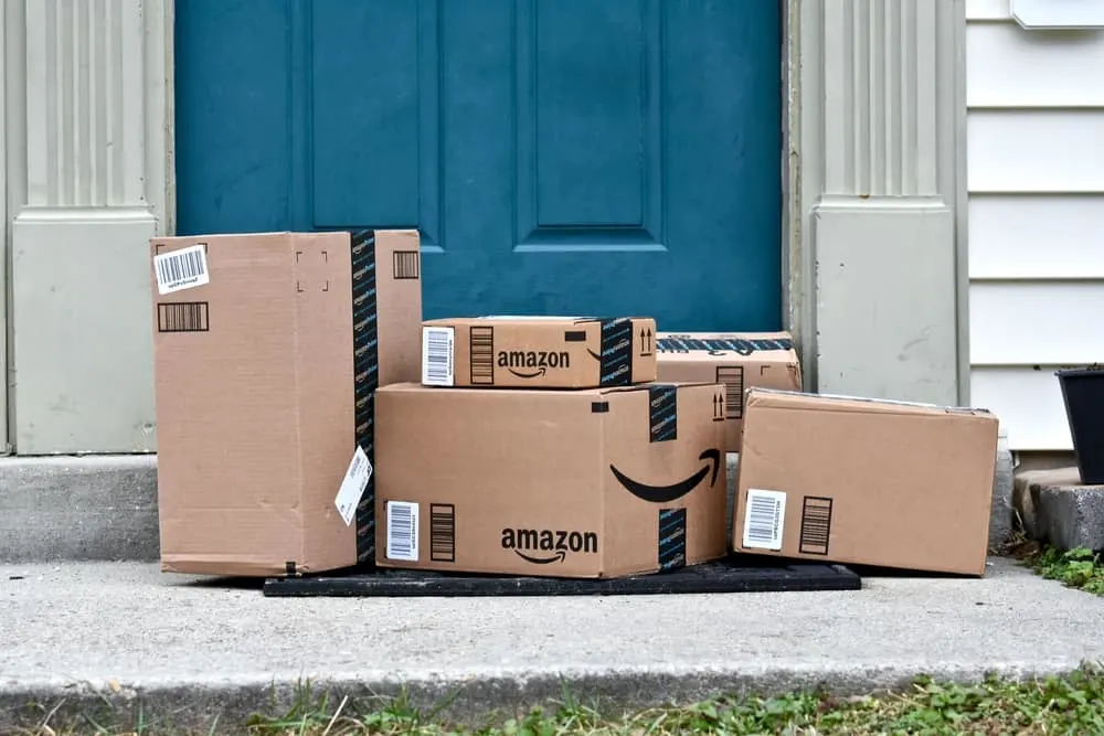 amazon boxes at front door that is blue