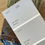 gray paint chips on top of paint brush
