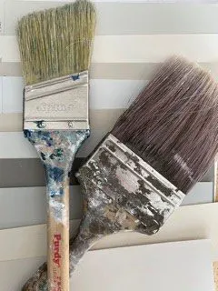 paint brushes on top of paper paint chips