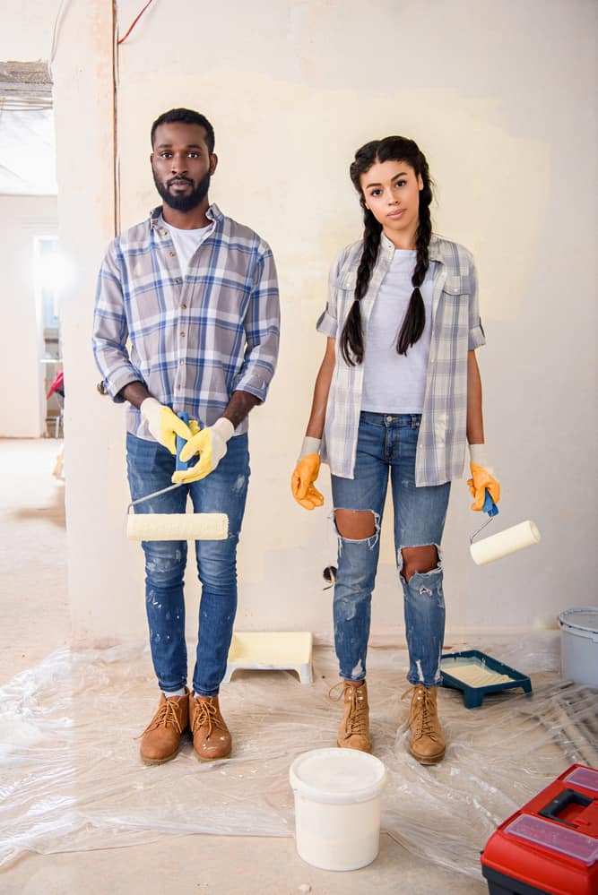 couple standing with painting tools