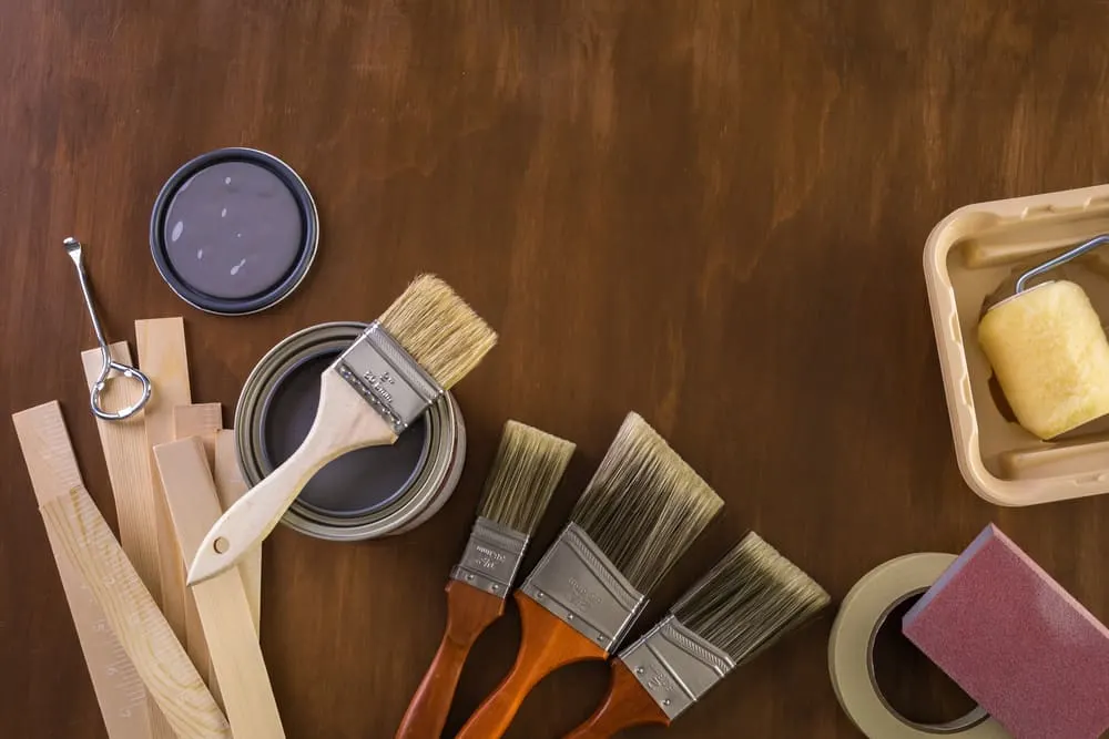 painting tools on a wood floor