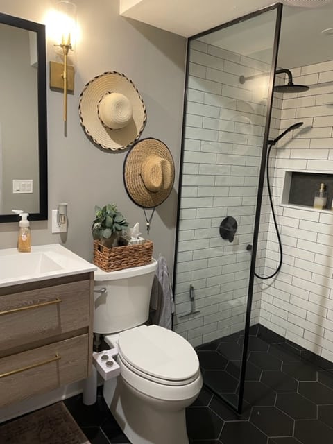 gray bathroom with hats on teh wall