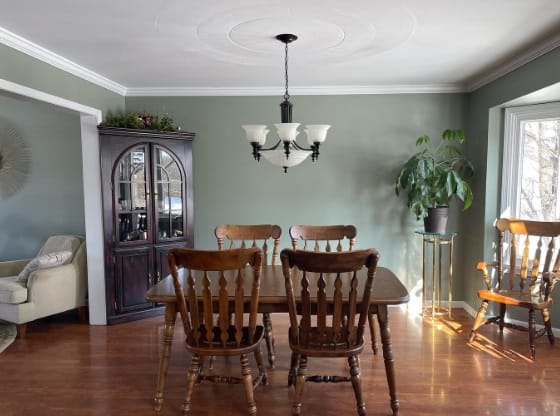 dining room with green-gray paint on the walls