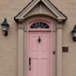 tan house exterior with pink front door