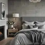 bedroom with cozy bed and night stand and artwork in neutral gray colors