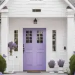 a white house with a lavendar front door