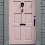 pink front door on gray house