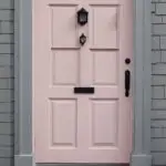pink front door on gray house