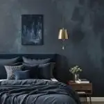 Deep blue bedroom with a bed with blue bedding