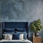 small bedroom with textured blue walls and bed