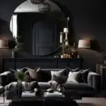 _neutral living room with black walls, couch and large round mirror