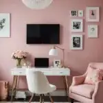 pink walls in office with desk , chair and art on walls