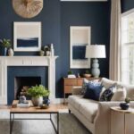 Living room with navy blue walls, neutral couch and fireplace