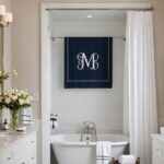 large Bathroom with white towels with a navy blue monogram