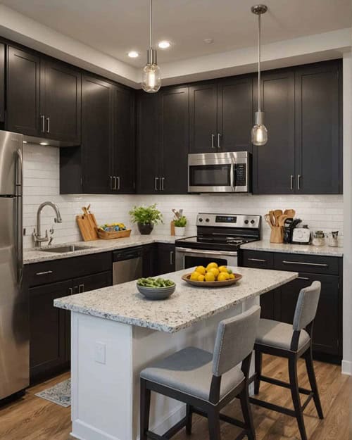 small apartment kitchen with black cabinets and white island