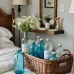 basket of blue and clear bottles on a bed