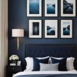 bedroom with be nightstand, navy blue walls and large window with cream curtains