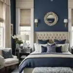 bedroom with bed, mirrored nightstand, navy blue walls and large window with cream curtains