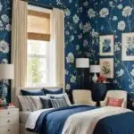 bedroom with bed, night stand , chairs and blue floral wallpaper on the walls