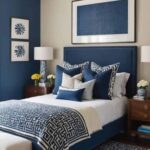 bedroom with bed, wood night stands, blue and cream walls and large art over the bed