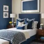 bedroom with bed, wood night stands, blue and cream walls and large art over the bed