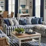 coastal living room with blue and white striped couch, square coffee table and blue curtains on windows