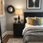 guest bedroom with bed, night stand and picture above the bed