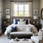 guest bedroom with queen bed in front of a window and a bench and chair at the foot of the bed