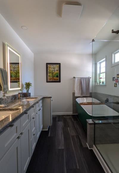 Bathroom with glass shower, double vanity and white walls