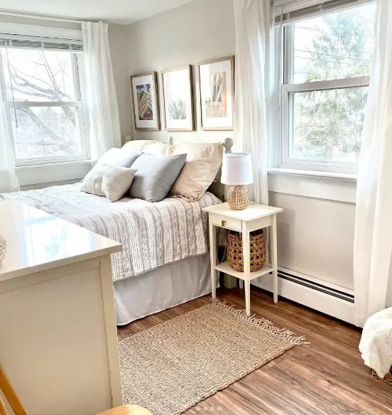 Bedroom with bed two windows and white walls