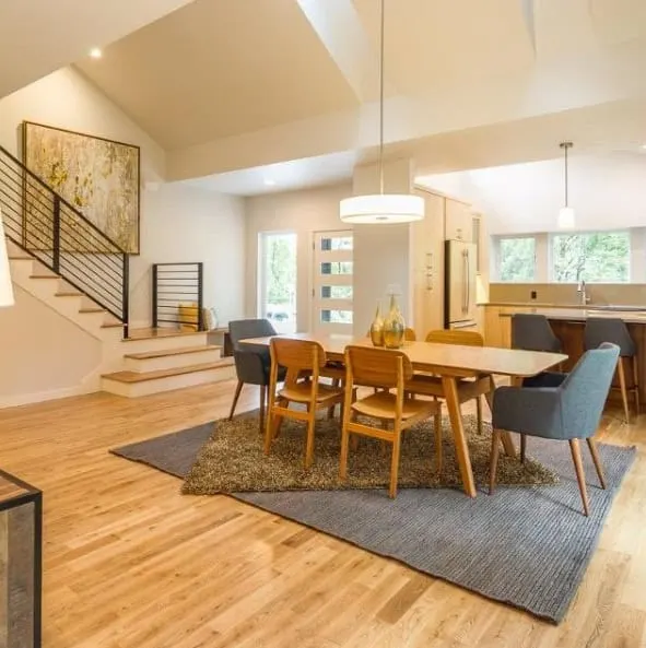 Open concept dining room living room with high ceilings and Eider White painted walls