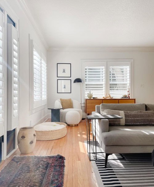 white walls in bright living room with couch and dog bed