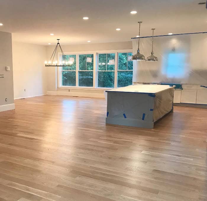 large open concept kitchen with windows and kitchen island