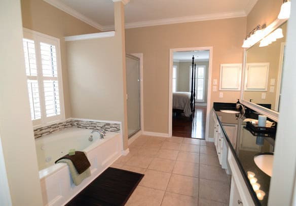 shaker beige paint walls in master bathroom with double sink vanity and bathtub