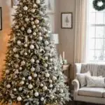 A room decorated for Christmas with neutral colors and a flocked christmas tree