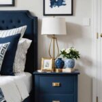 Bedroom with bed, small navy blue nightstand and neutral walls