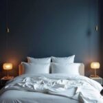 bedroom with navy blue walls, bed with white bedding,