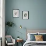 bedroom with blue walls, window, bed and two frames on the wall