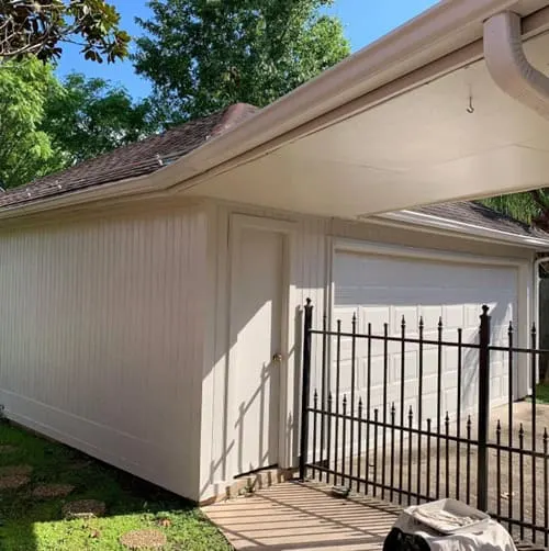 Garage Exterior painted in Skyline Steel with black fence in front