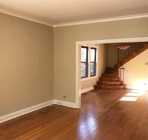  an empty living room with a staircase