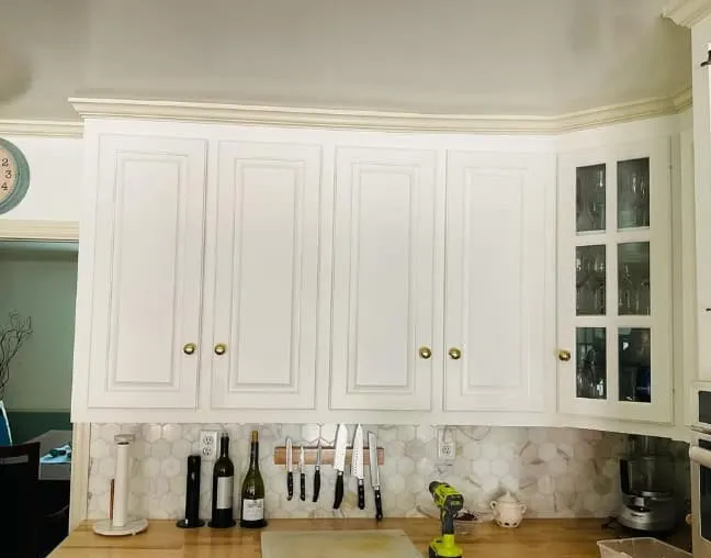 white upper kitchen cabinets with gold knobs