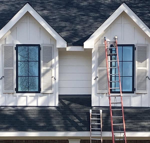 white exterior of a home with gray shutters