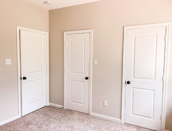 bedroom with three doors