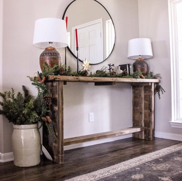 entryway with table and round mirror
