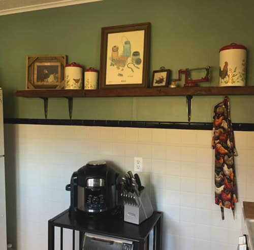 Green kitchen wall with shelf